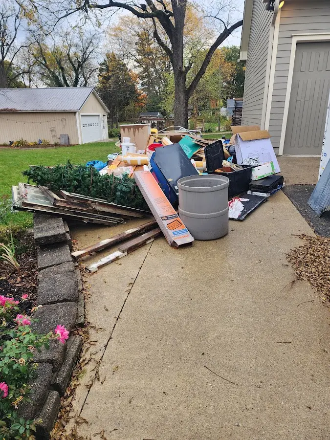 Dumpster being loaded with debris for Roofing Dumpster Rental in West Point